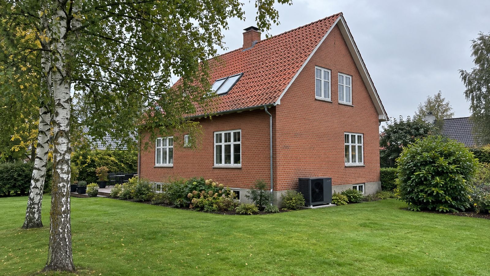 Dansk parcelhus med nyanlagt indkørsel i grå betonsten